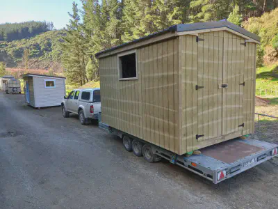 A garden shed is loaded and ready for delivery.