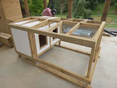 A fully insulated dog kennel under construction.