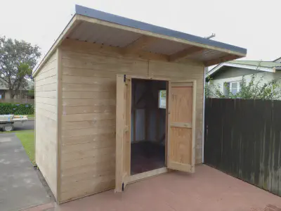 A Tom Good garden shed with extended roof.